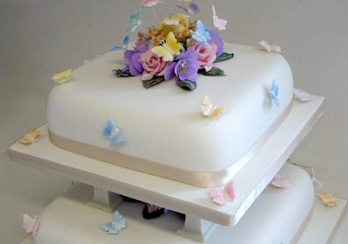 A traditional 3-tier Wedding Cake with flowers